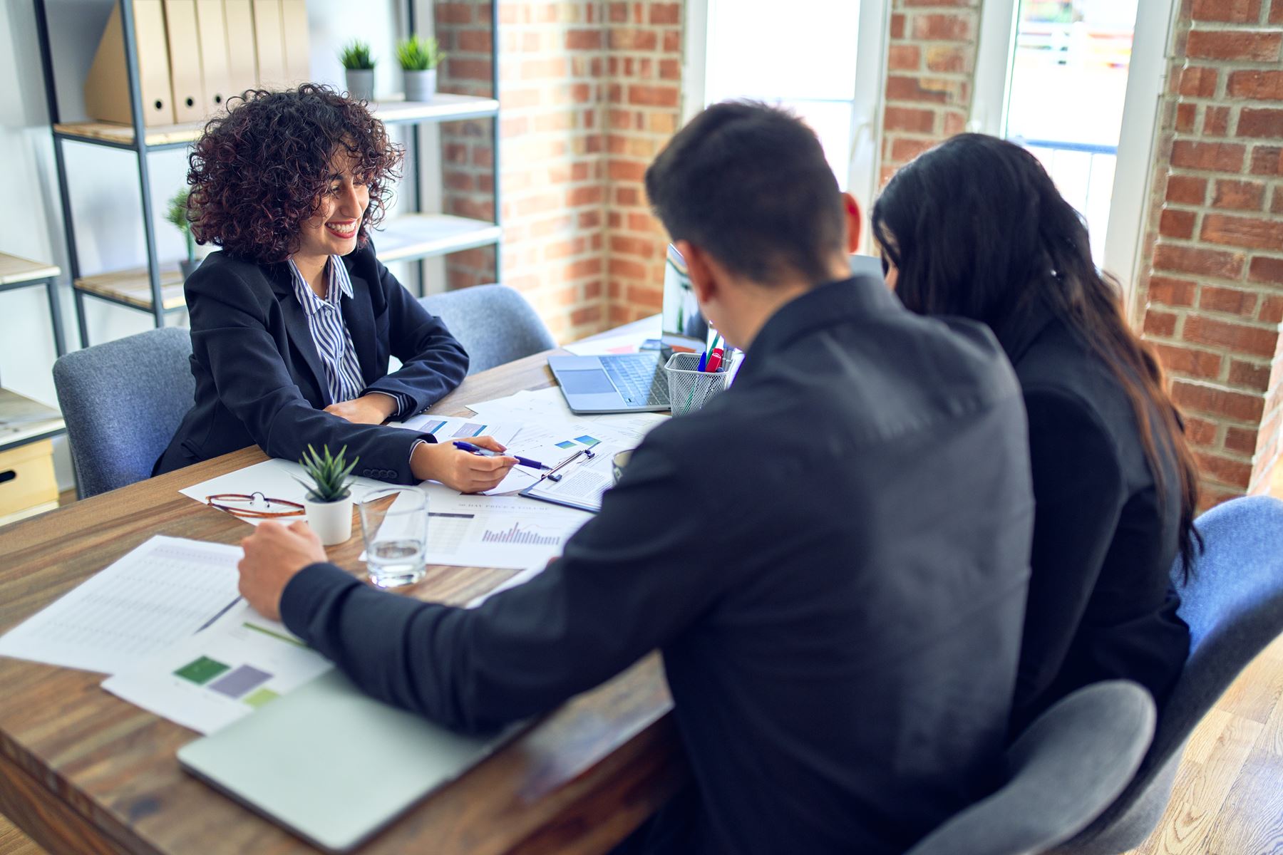 Banker going over loan information with couple