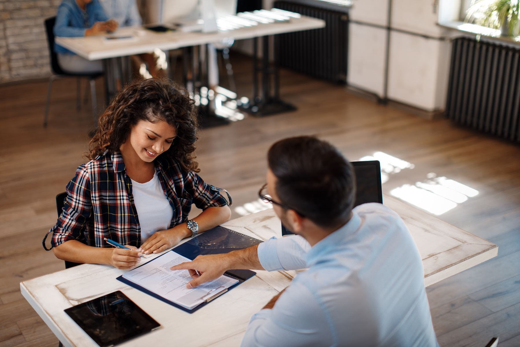 client going over paperwork with professional