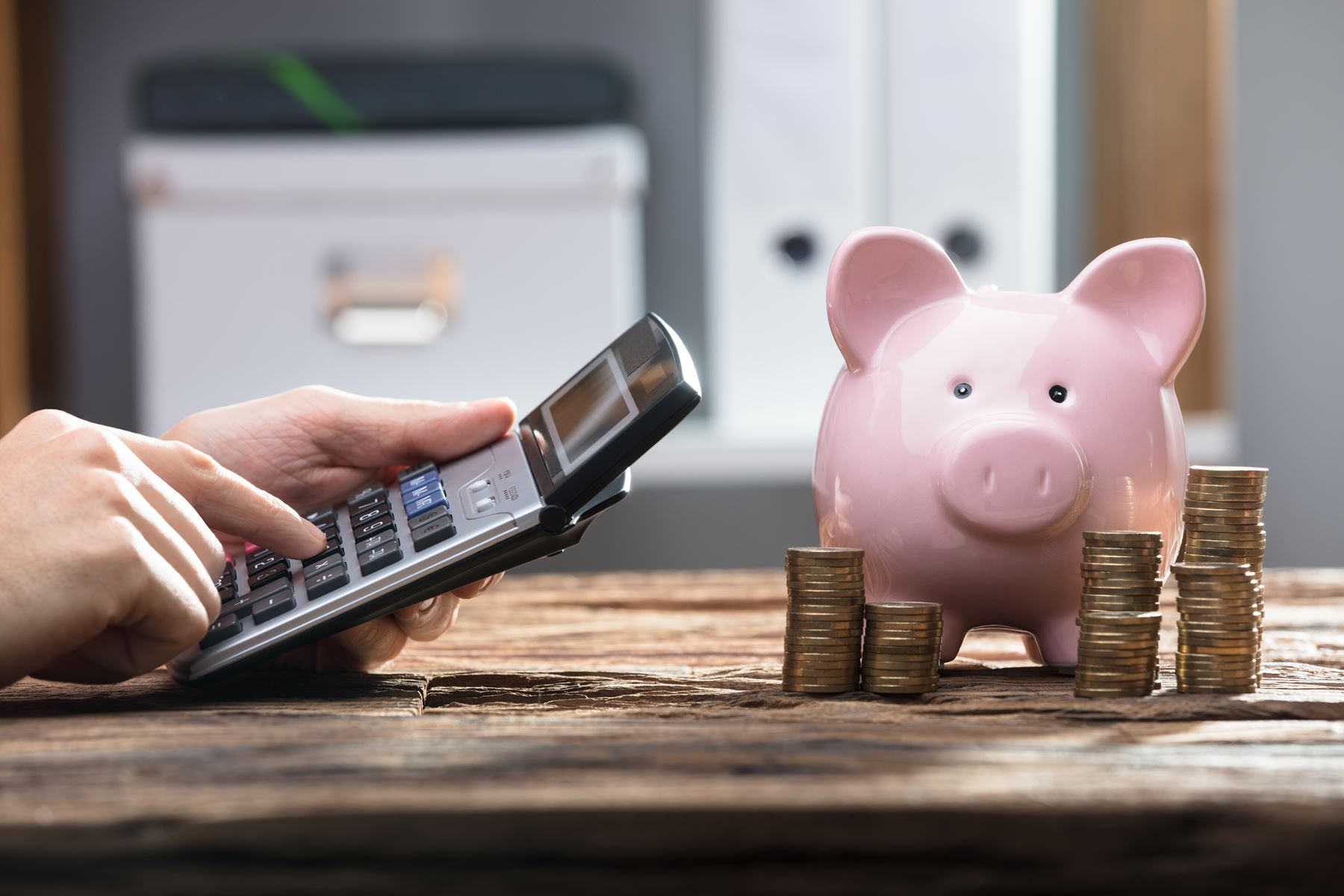 piggy bank next to calculator