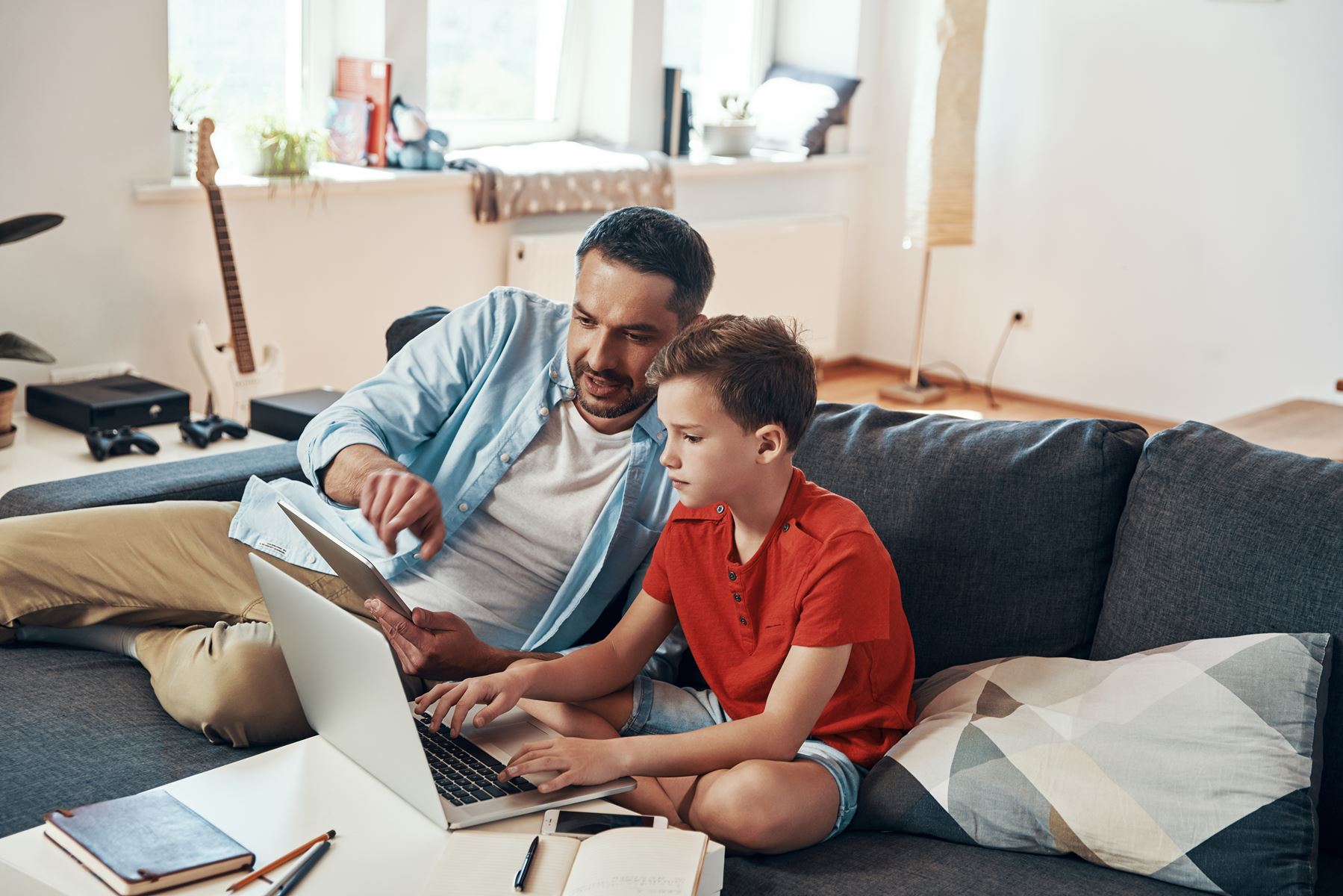 Dad using computer with son